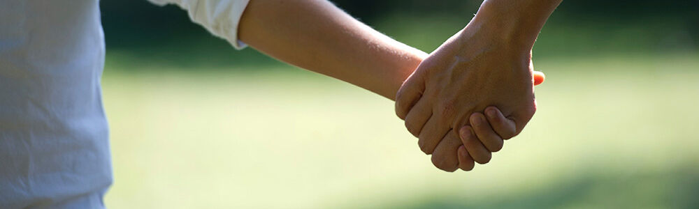 Holding hands outside cropped